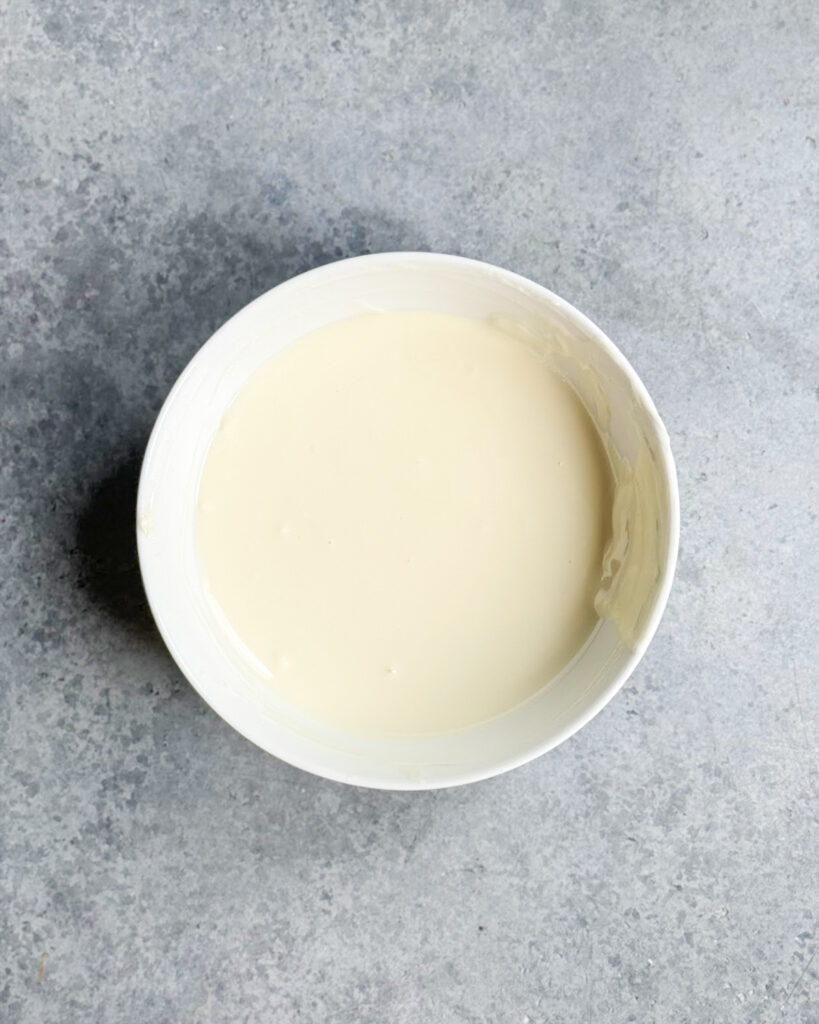 A bowl of melted white chocolate.