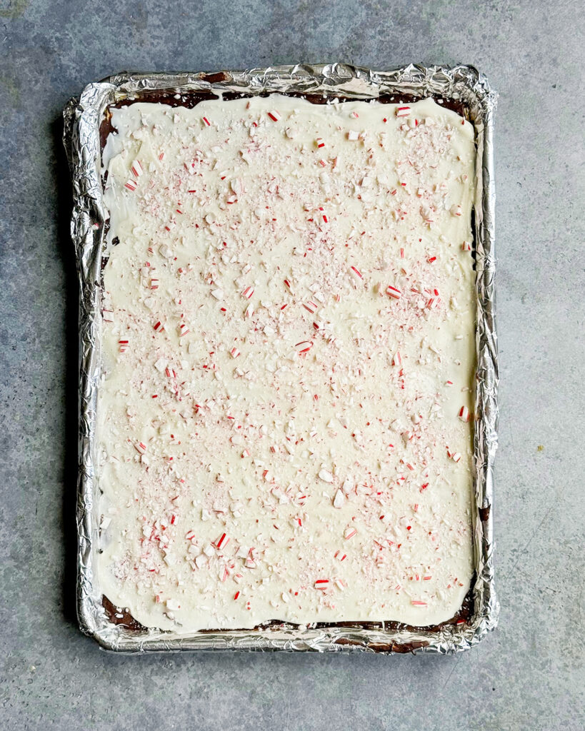 An above view of Peppermint Bark Cracker Toffee, showing the white chocolate and candy cane on top.