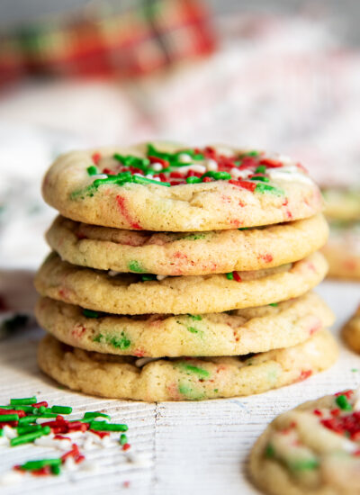 A stack of 5 Christmas Funfetti cookies with red, white, and green sprinkles.