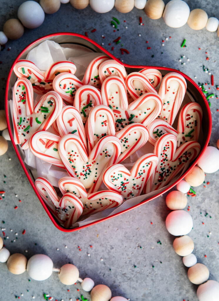 Candy cane hearts in a red heart shaped tin.