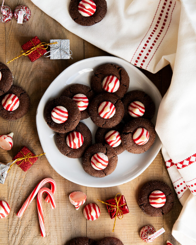 A plate of chocolate blossom cookies topped with Peppermint Kisses.