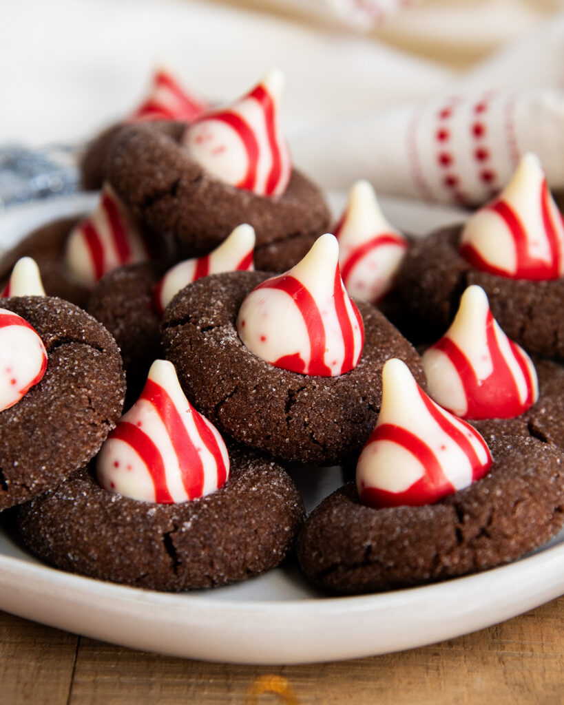 A plate of chocolate blossom cookies topped with Peppermint Kisses.