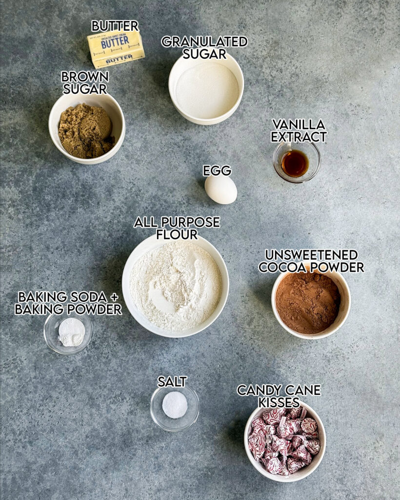 Small bowls of the ingredients needed to make chocolate peppermint kiss cookies. 