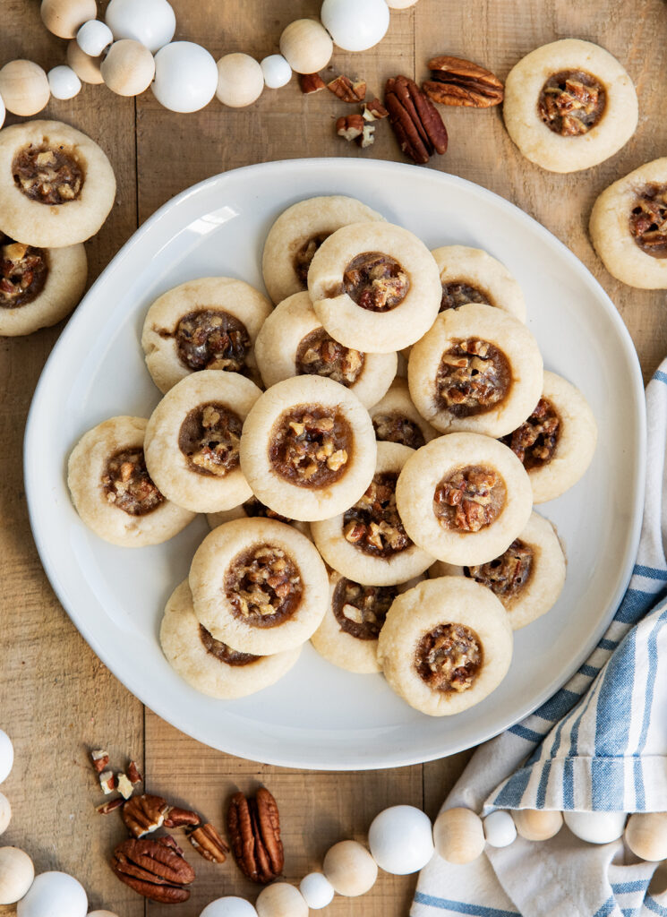 An above view of a plate of pecan pie thumbprint cookies. 