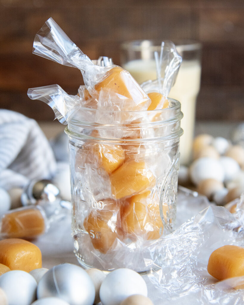 A jar of wrapped eggnog caramels.