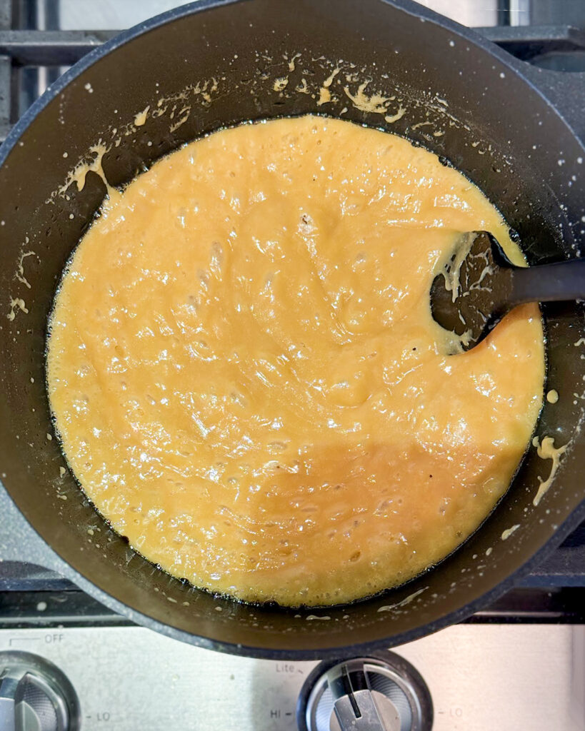 Gooey liquid caramel in a pot.