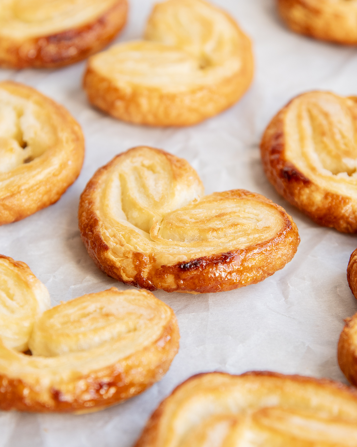 Heart Shaped Palmier Pastries on a white piece of parchment paper.