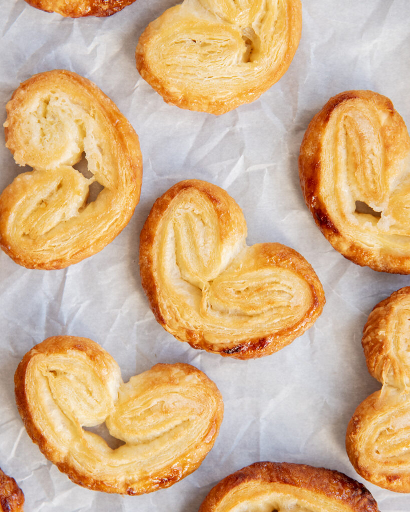 Heart Shaped Palmier Pastries on a white piece of parchment paper.