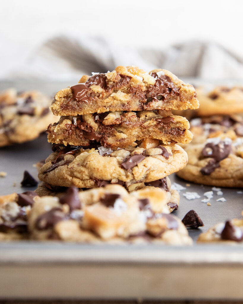 A stack of saltine cracker cookies, and the top is cut in half showing the gooey cookie center.