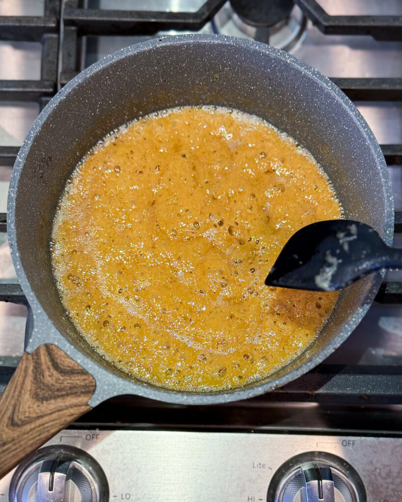 Golden toffee in a small pot.