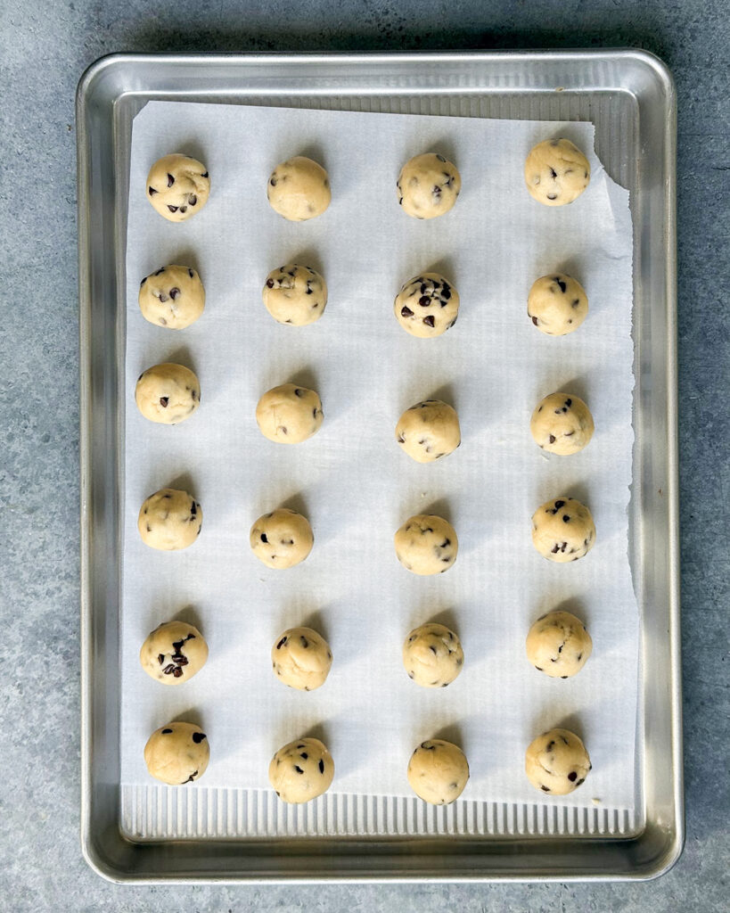 Cookie dough rolled in balls on a cookie sheet.