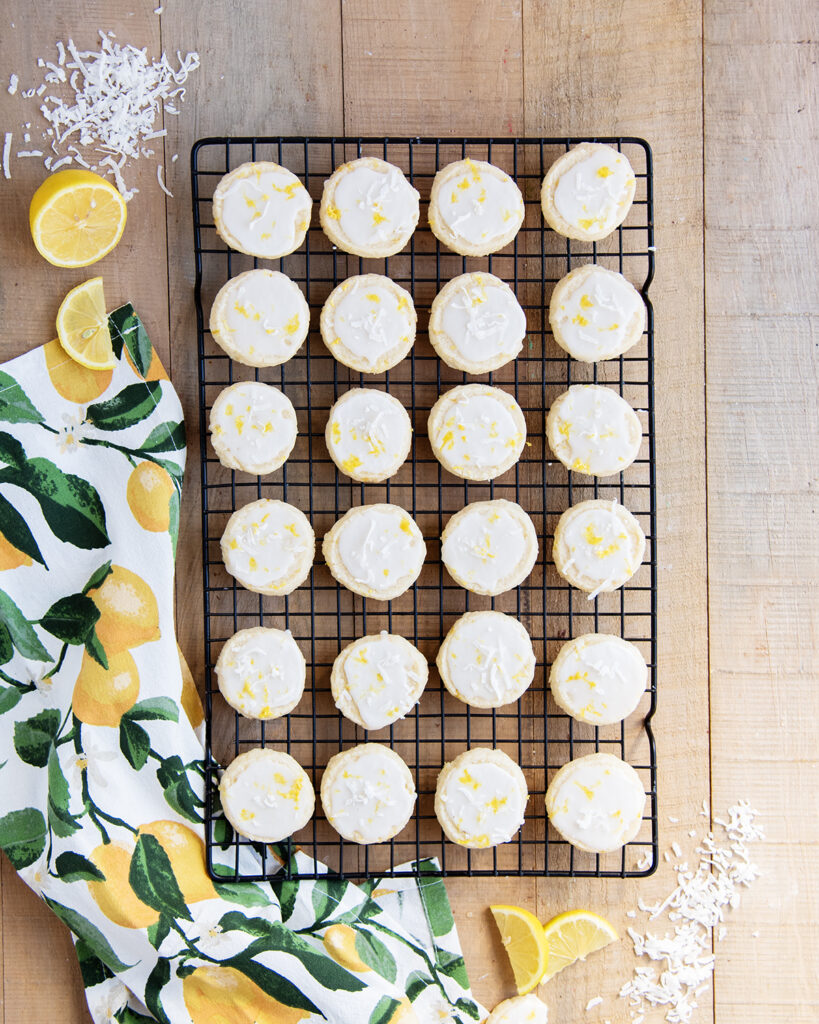 An above view of round shortbread cookies in rows on a wire rack.