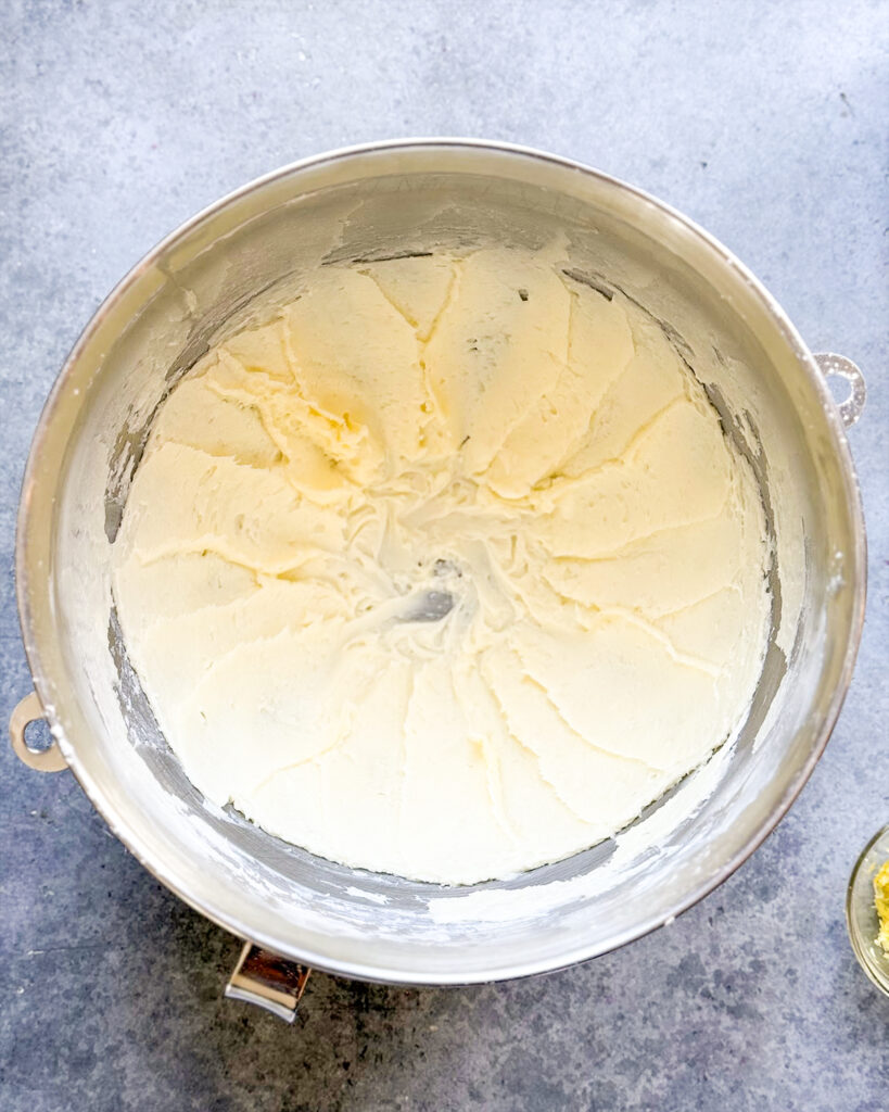 A bowl of creamed butter and powdered sugar.