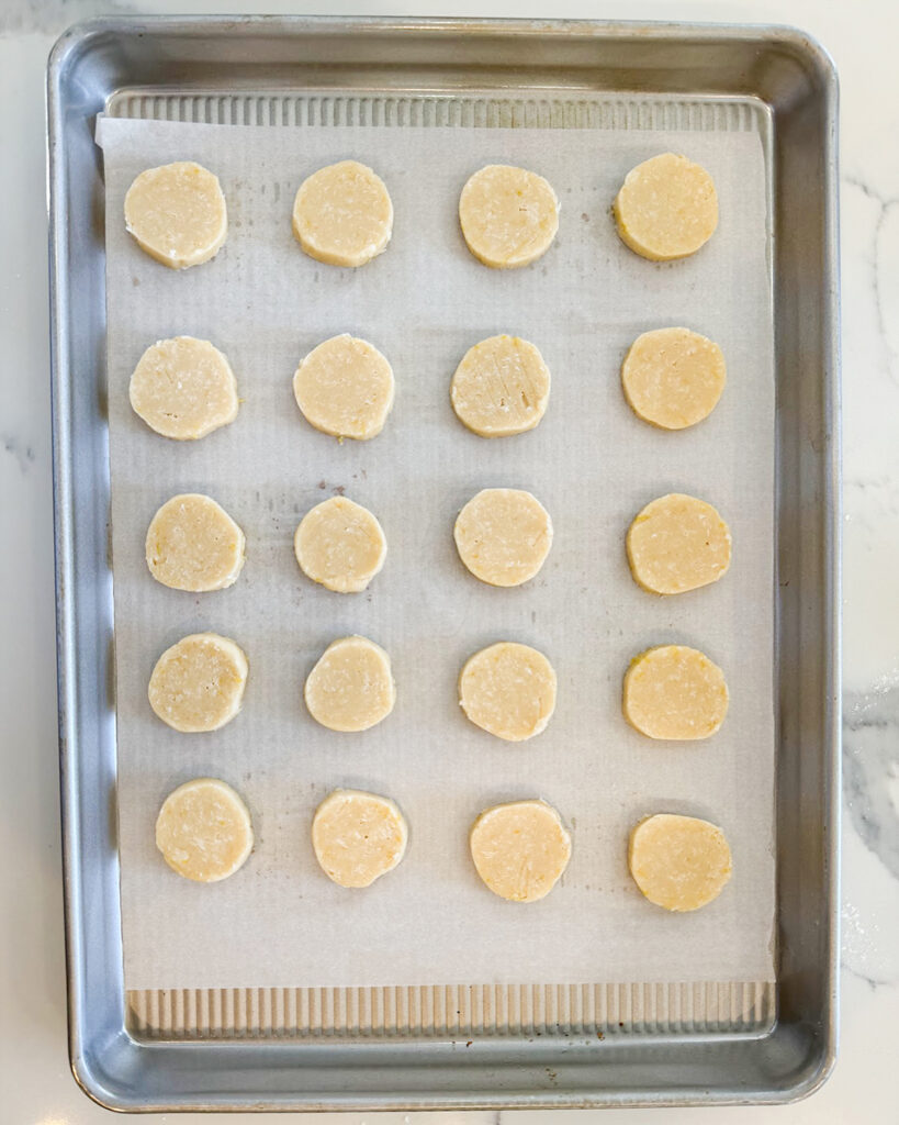 A pan of round shortbread cookie dough slices.