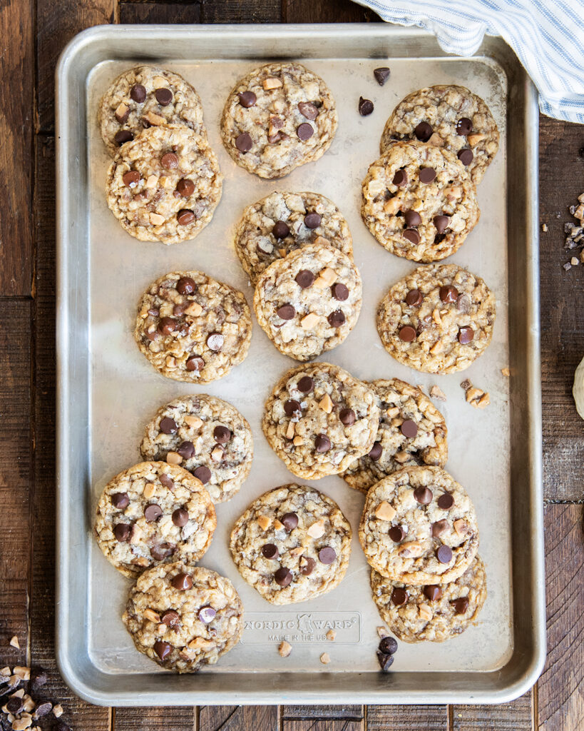 An above view of a cookie sheet topped with oatmeal toffee and chocolate chip cookies.