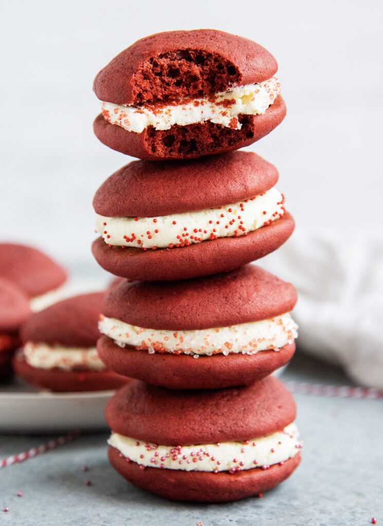 Four red velvet whoopie pies in a stack.