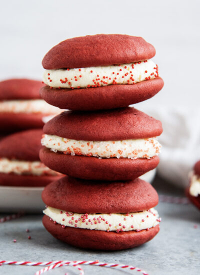 Three red velvet whoopie pies in a stack.