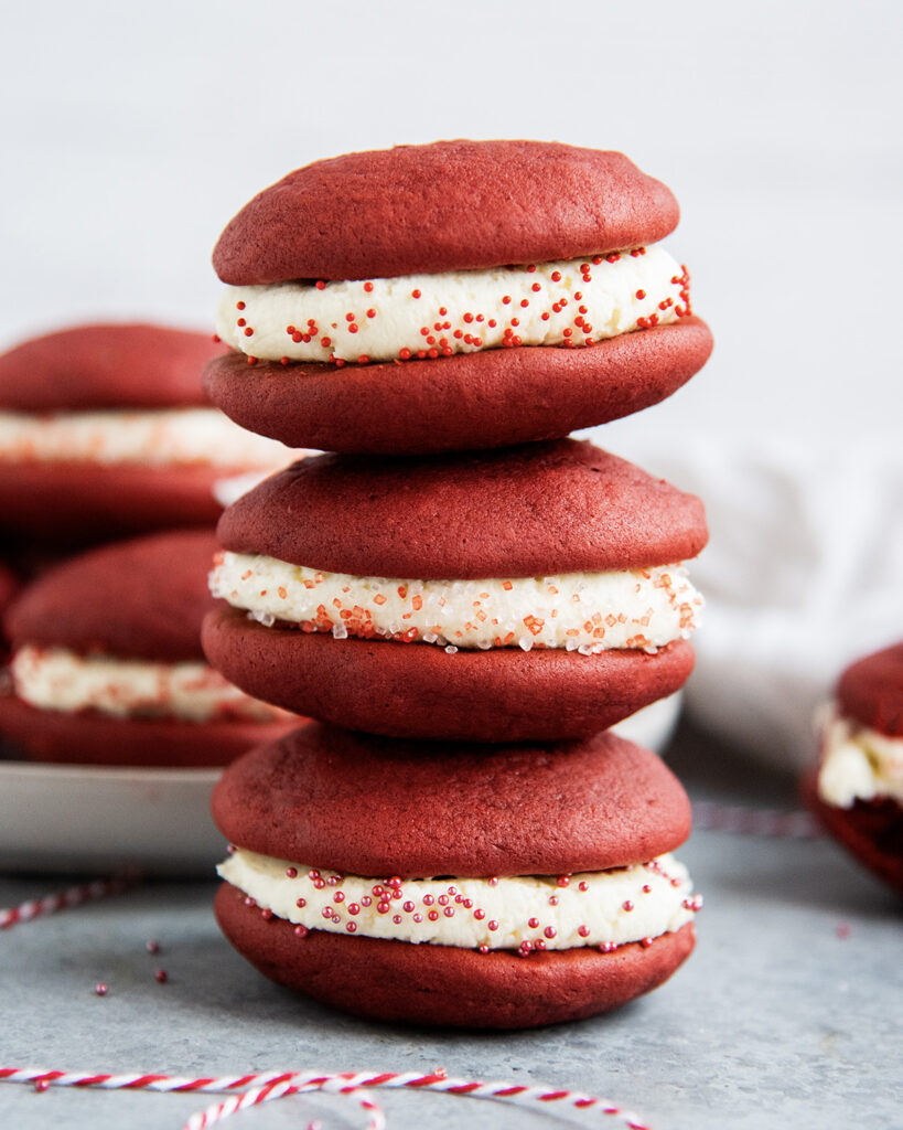 Three red velvet whoopie pies in a stack. 