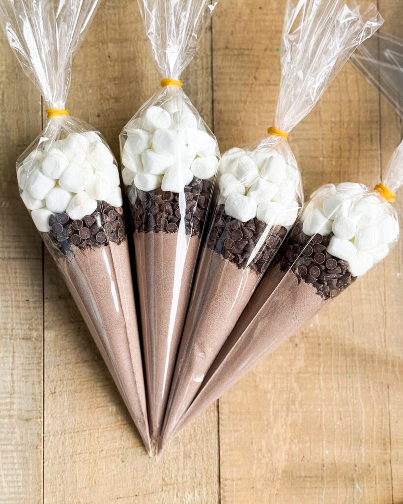 Four Hot chocolate cones with cocoa mix, mini chocolate chips, and mini marshmallows. 