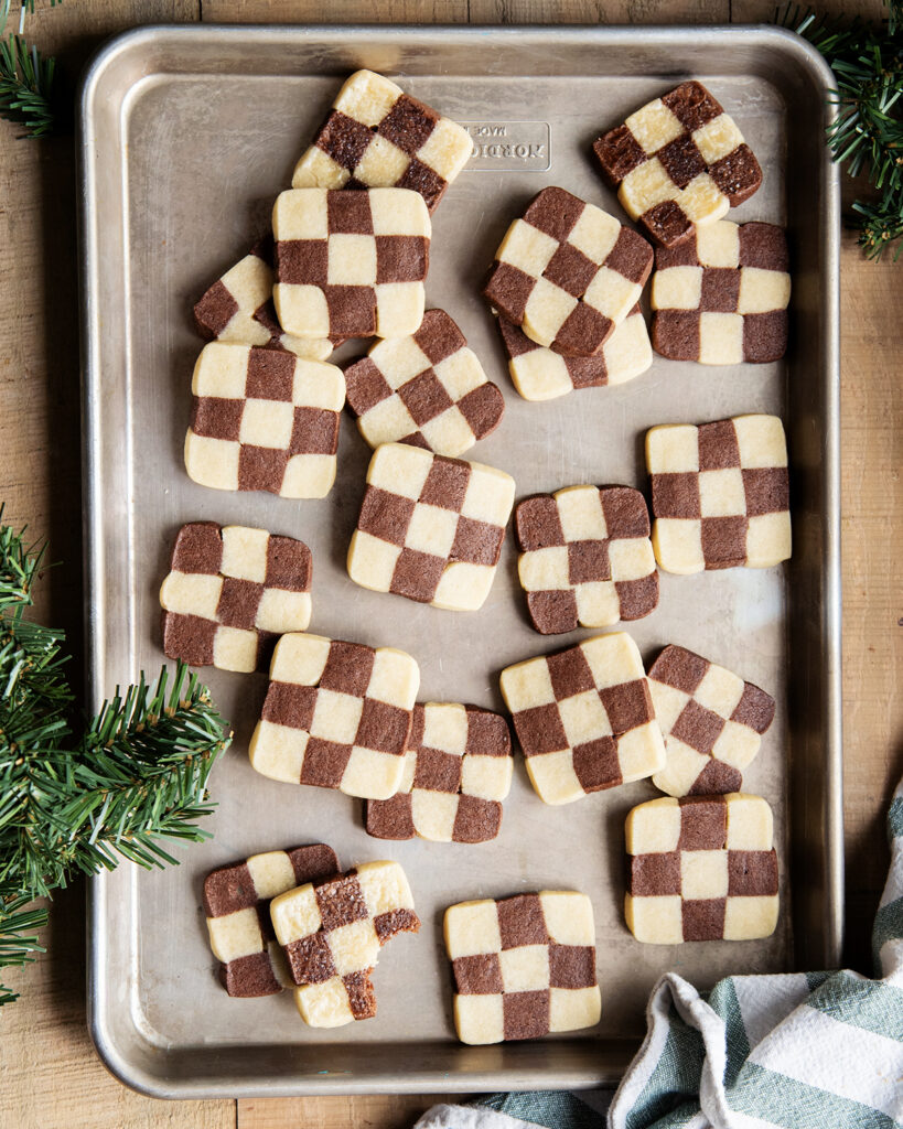 An above view of a cookie sheet topped with checkerboard cookies. 