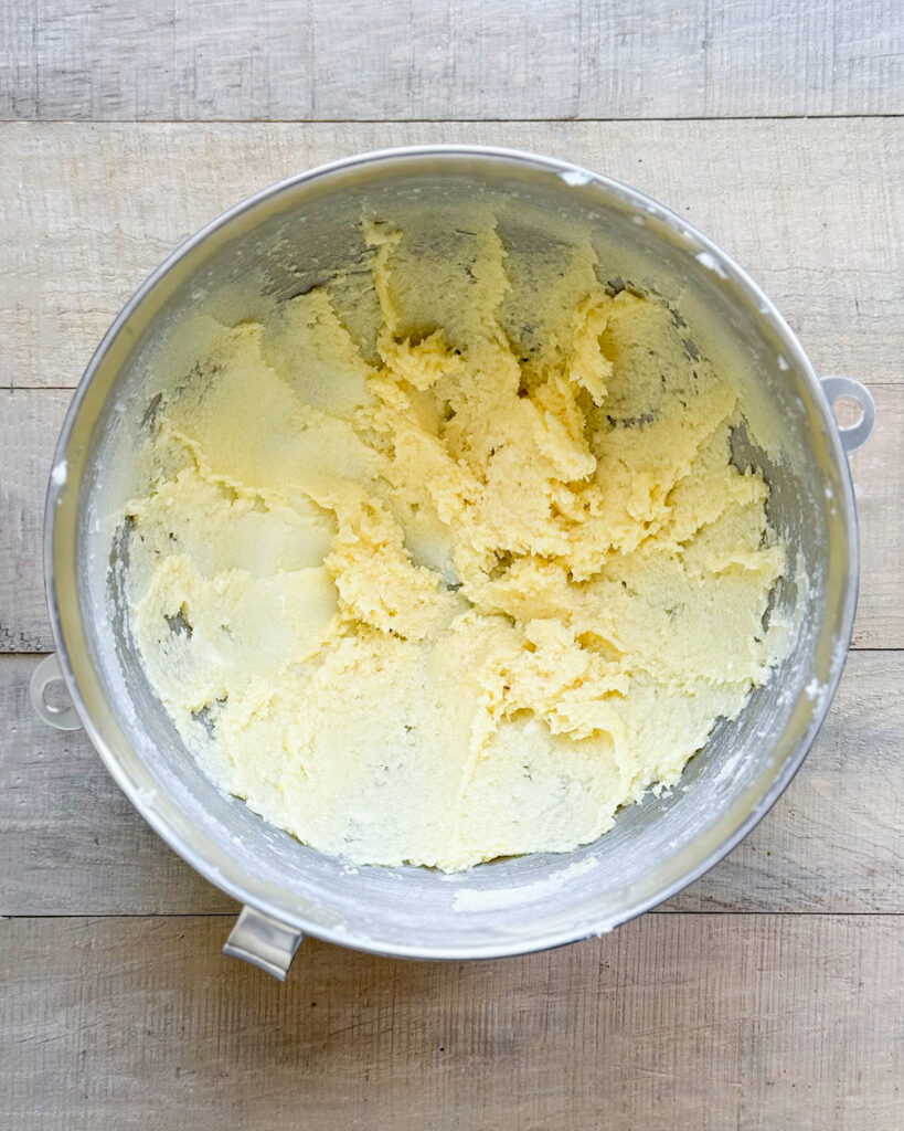 A bowl of creamed butter, sugar and eggs mixed. 