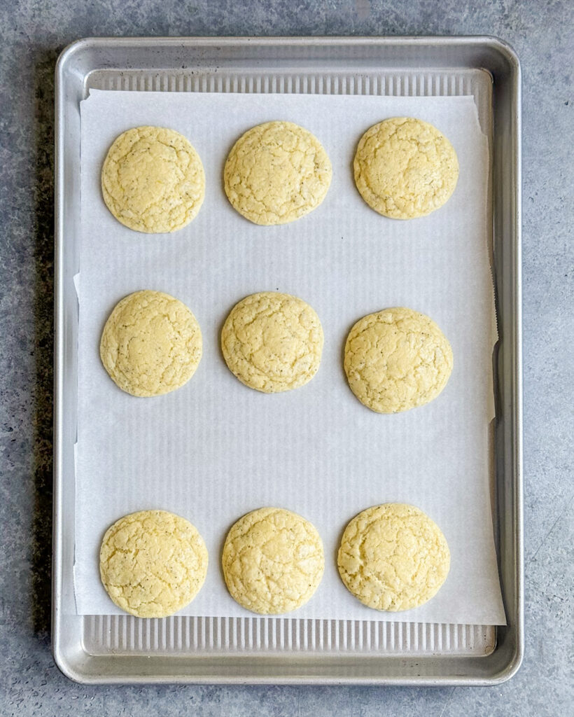 Baked lemon cookies on a cookie sheet.