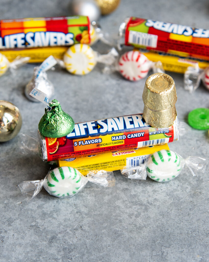 A candy train made with life savers, mints, rolos, and hershey kisses.