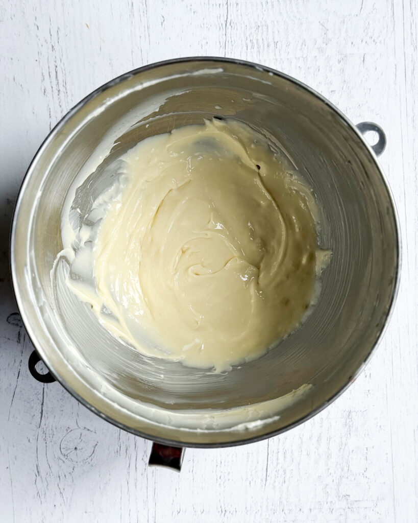 Cheesecake filling in a large mixing bowl.