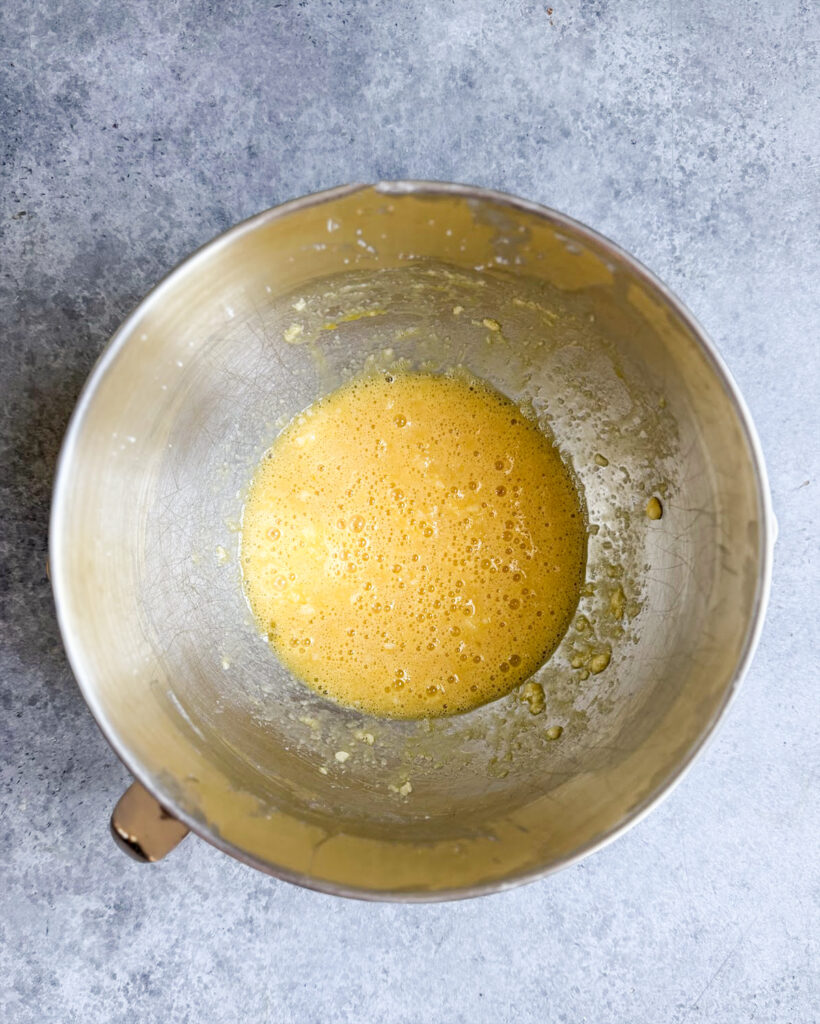 A bowl of mixed eggs, butter and sugar.