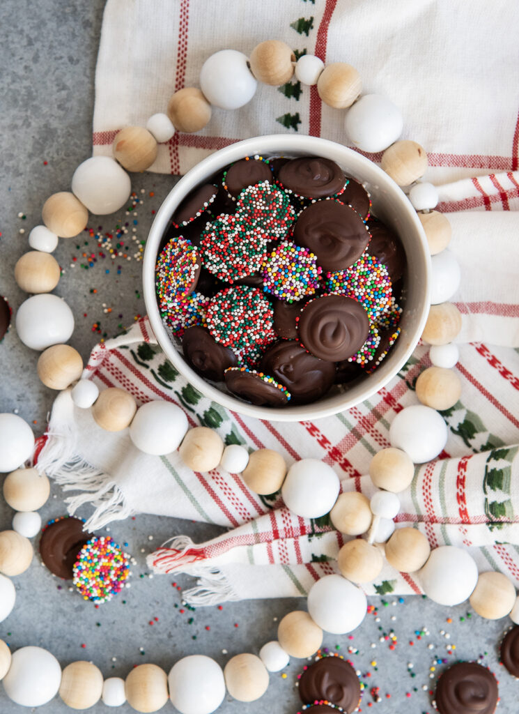 Chocolate Nonpareils in a small white bowl.