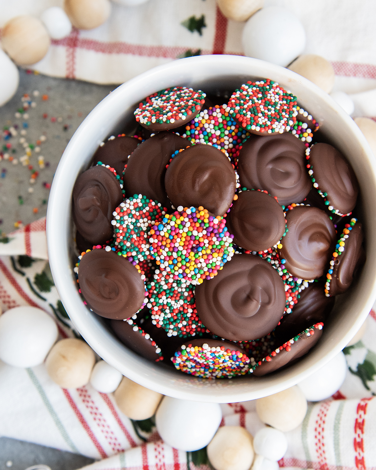 Chocolate Nonpareils in a small white bowl.