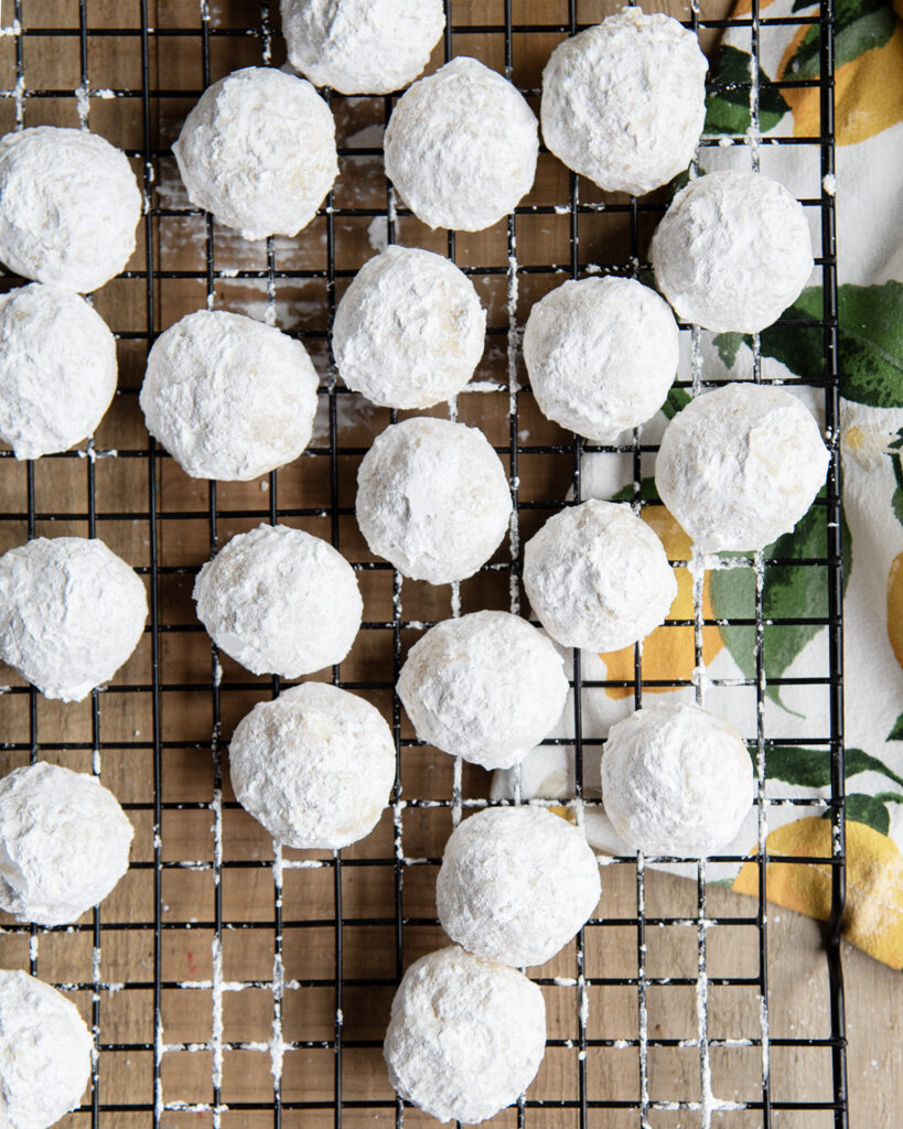 Snowball cookies on a wire cooling rack.
