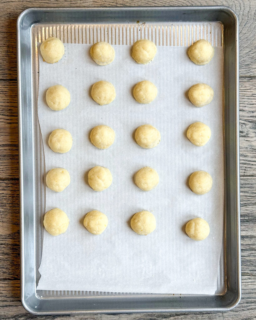 Lemon snowball cookies on a cookie sheet.
