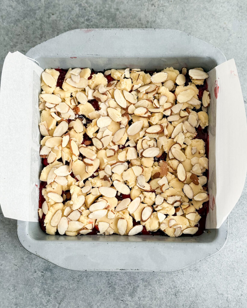 Raw cherry almond bars in a pan.