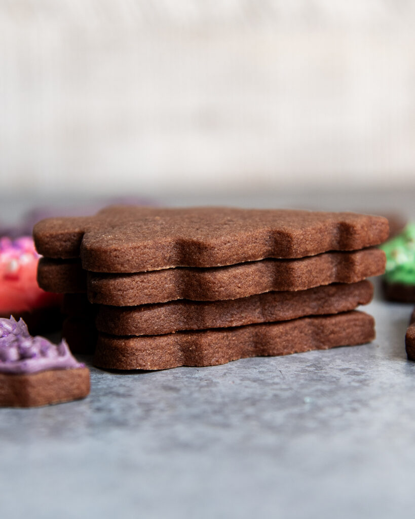 A stack of four chocolate cut out cookies.