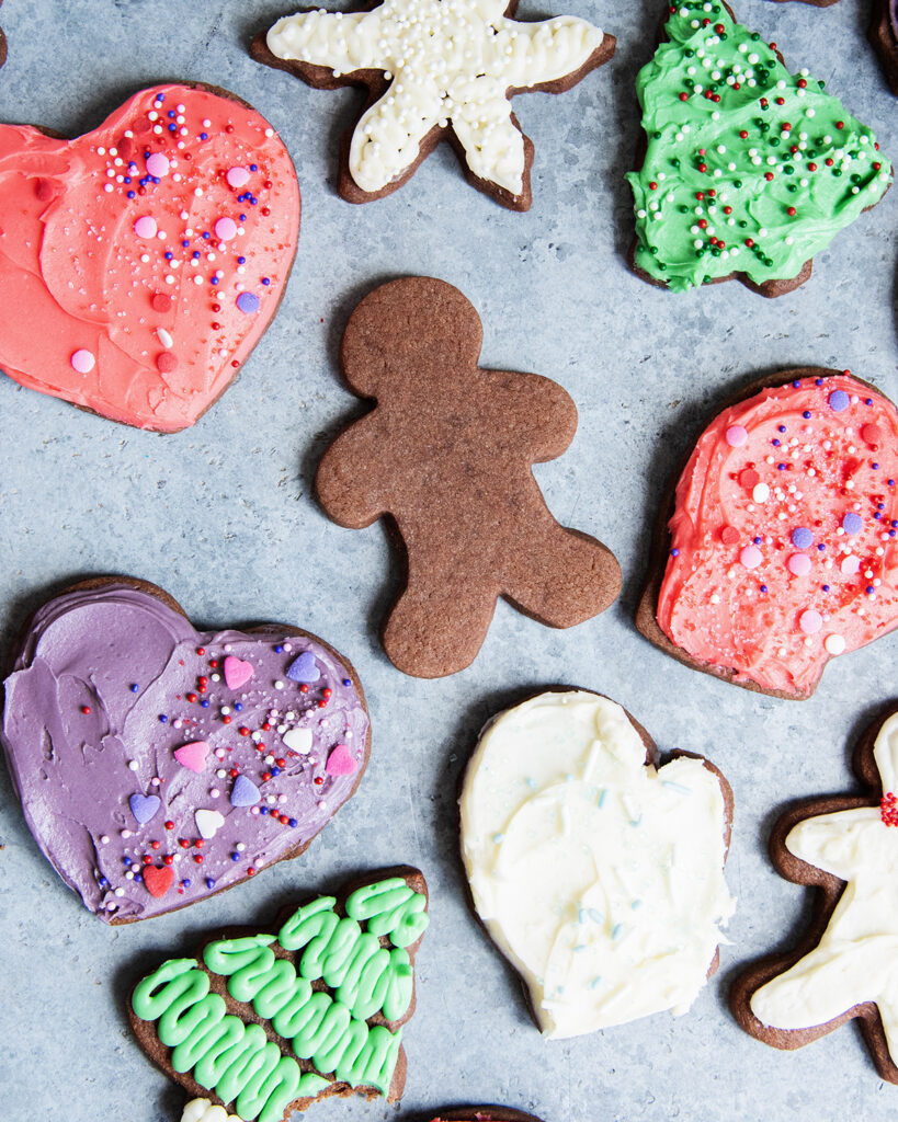 An above view of chocolate cut out cookies frosted with buttercream.