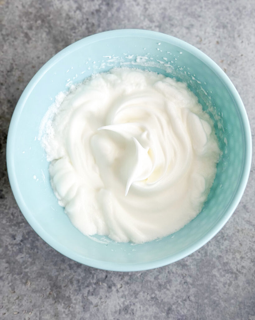 Whipped egg whites in a bowl.