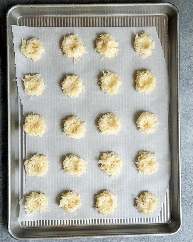 A coconut mixture on a cookie sheet before baking.