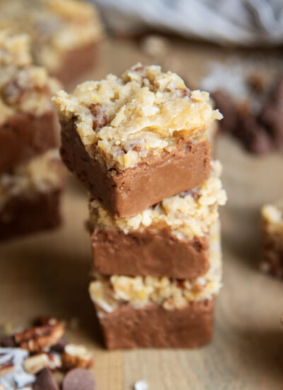 A stack of three pieces of fudge topped with German chocolate frosting.