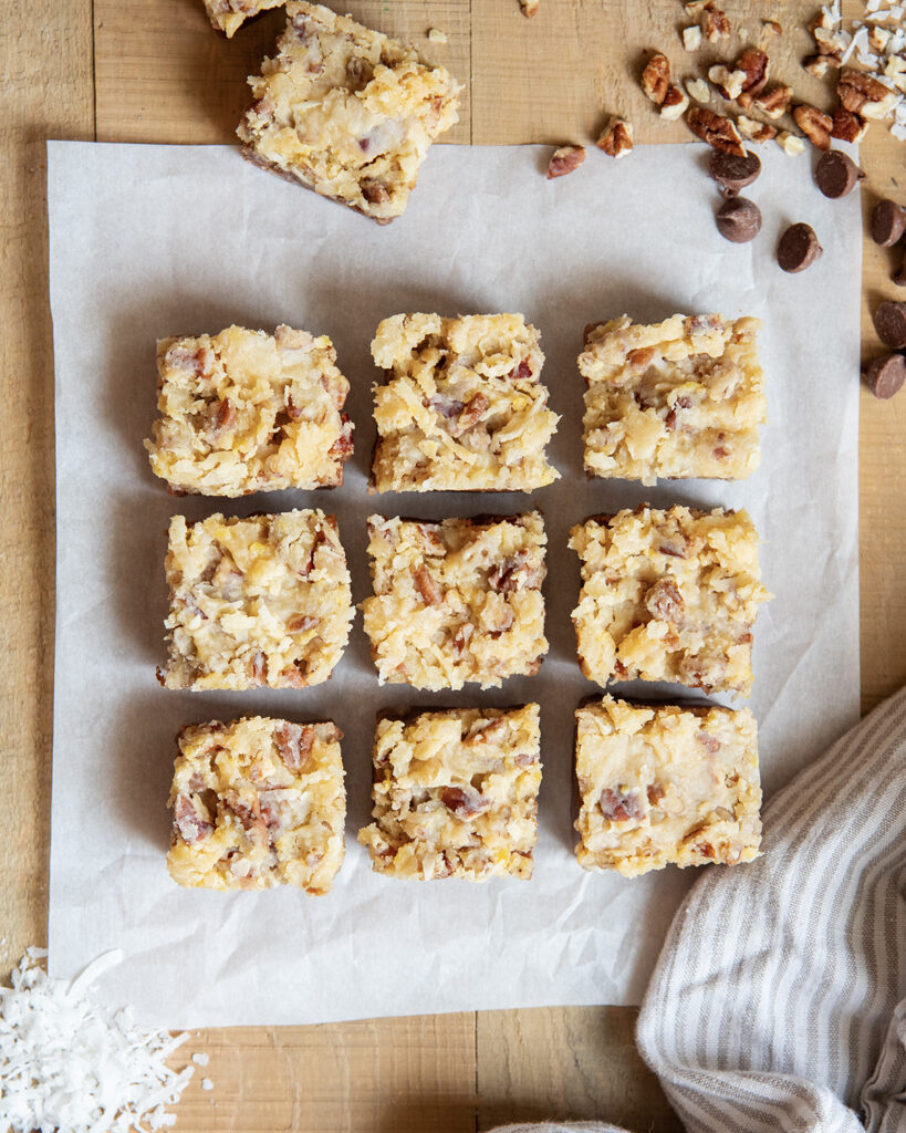 An above view of squares of candy topped with german chocolate cake frosting.