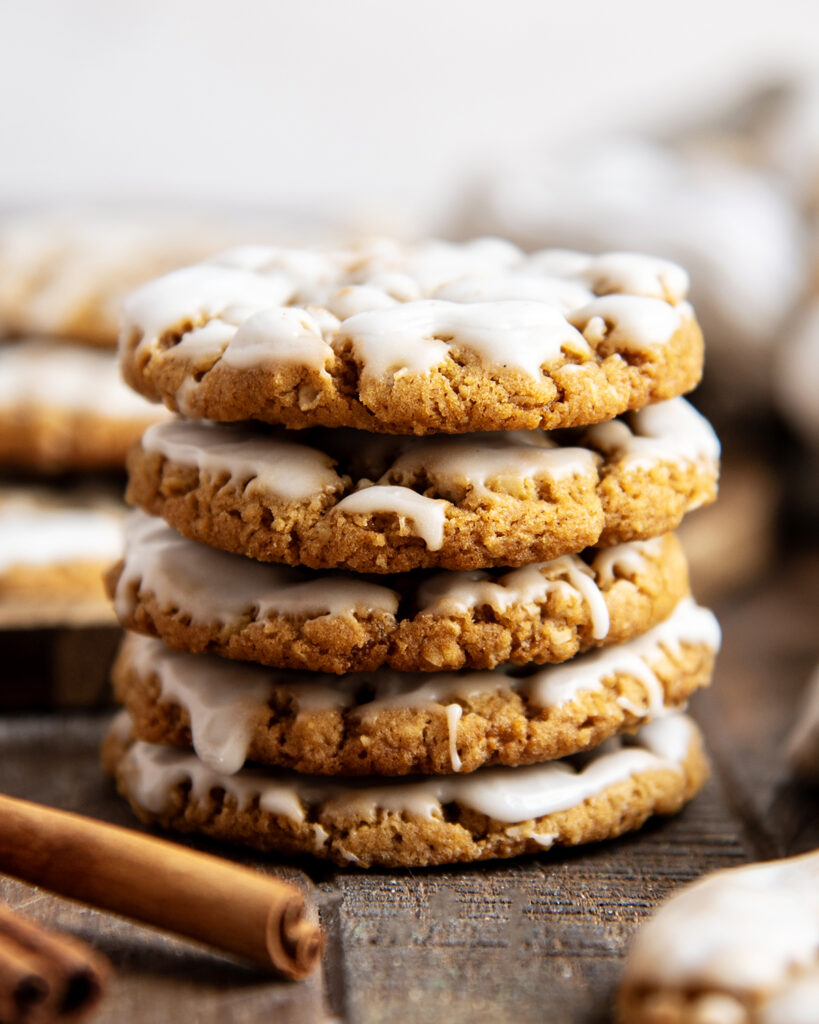 A stack of iced gingerbread oatmeal cookies.