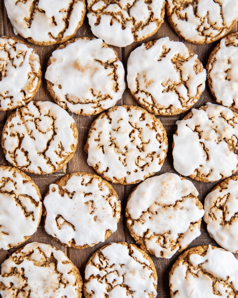 Offset rows of gingerbread oatmeal cookies with a white icing on top.