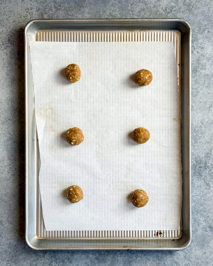 Balls of cookie dough on a cookie sheet.
