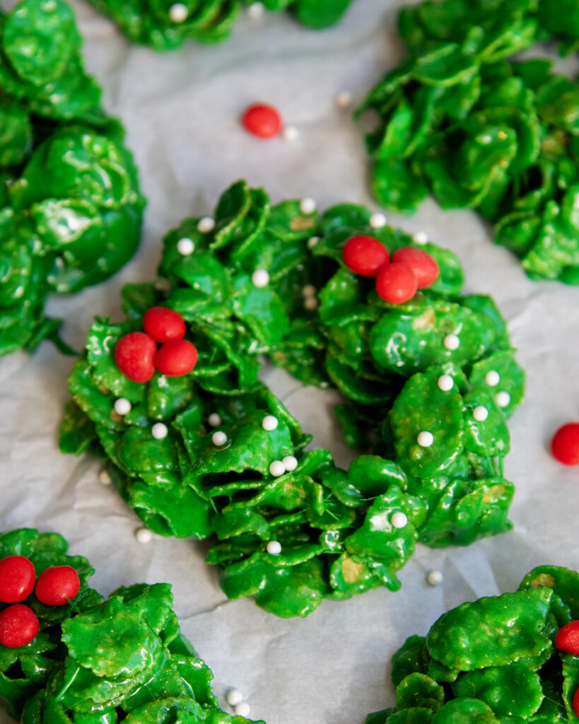 A cornflake wreath topped with cinnamon red hots and white sprinkles.