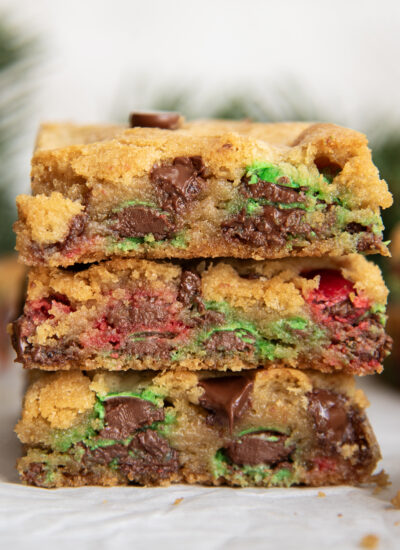 A stack of three pieces of Christmas M&M Cookie bars.
