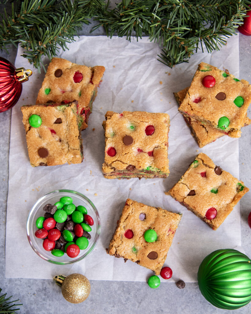 An above view of M&M cookie bars on parchment paper.