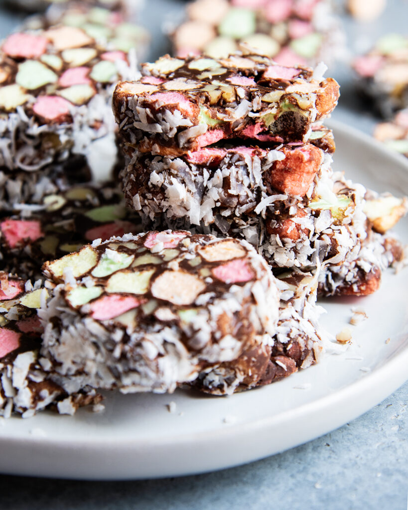 A plate of Church Window Cookies, in a pile and one on top has a bite out of it.