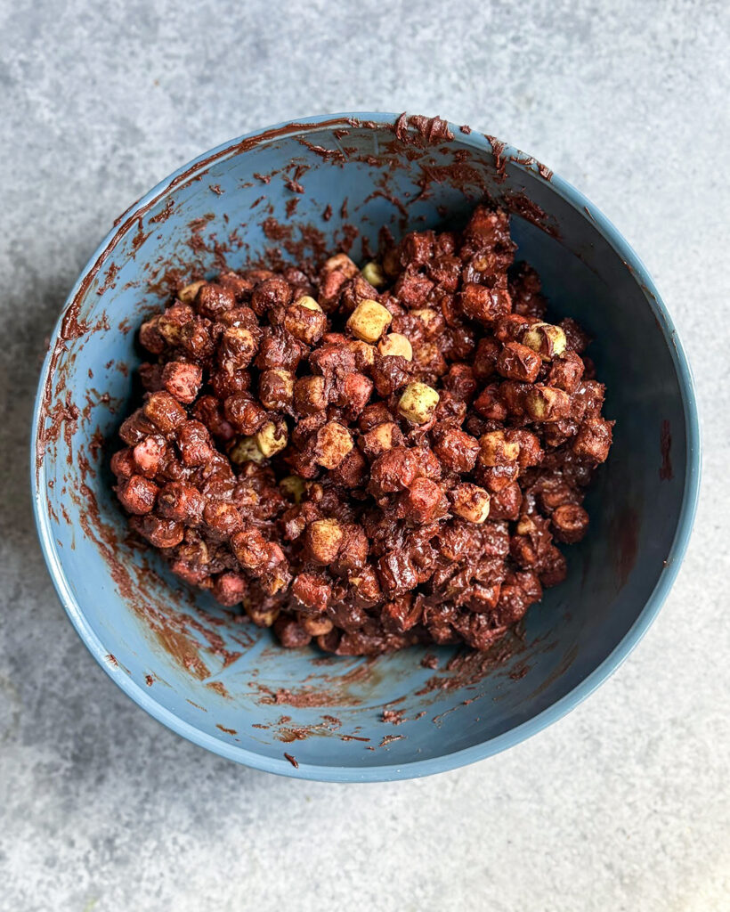 A bowl of chocolate coated mini marshmallows.
