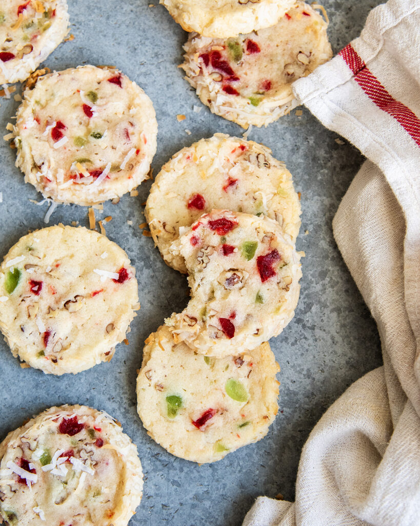 An above view of santa's whiskers cookies filled with red and green cherry pieces. 