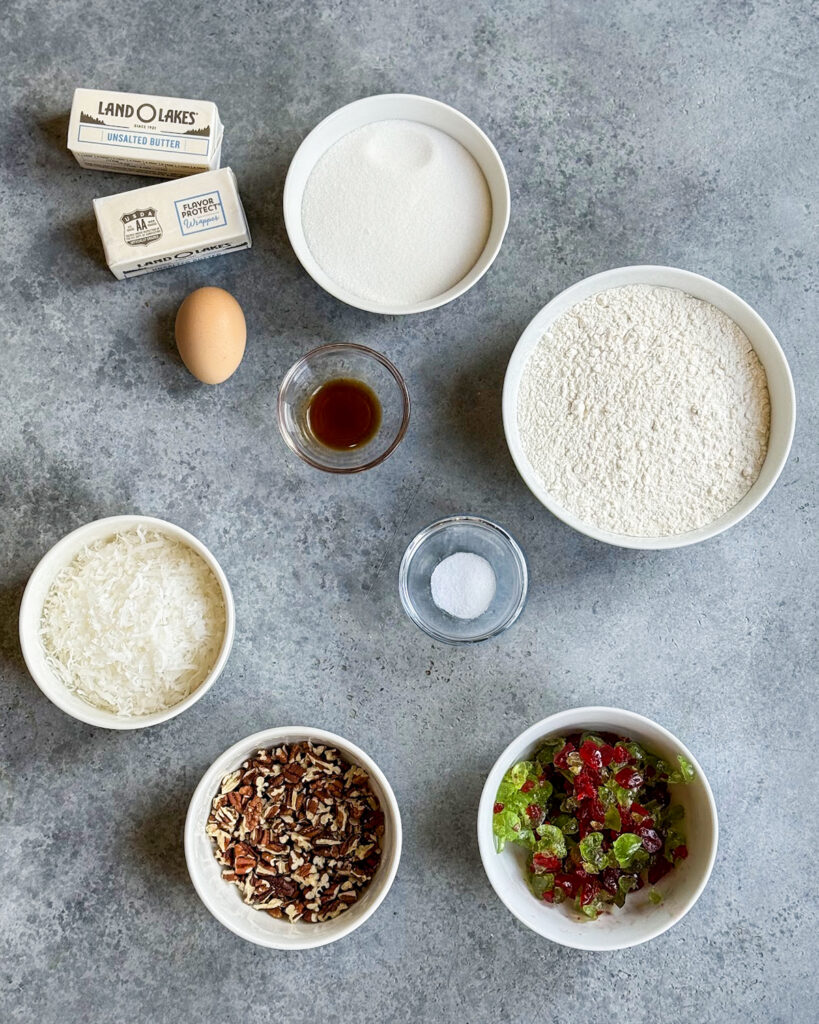 The ingredients needed to make Santa's Whiskers Cookies including butter, sugar, flour, and candied cherries. 
